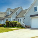 Modern residential home design by professional architects near me in Ludhiana featuring sleek glass and stone finish.