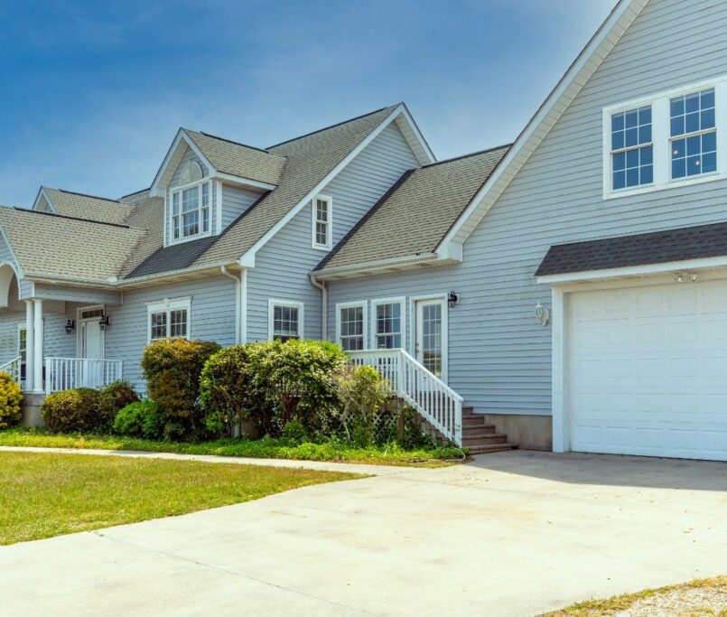 Modern residential home design by professional architects near me in Ludhiana featuring sleek glass and stone finish.