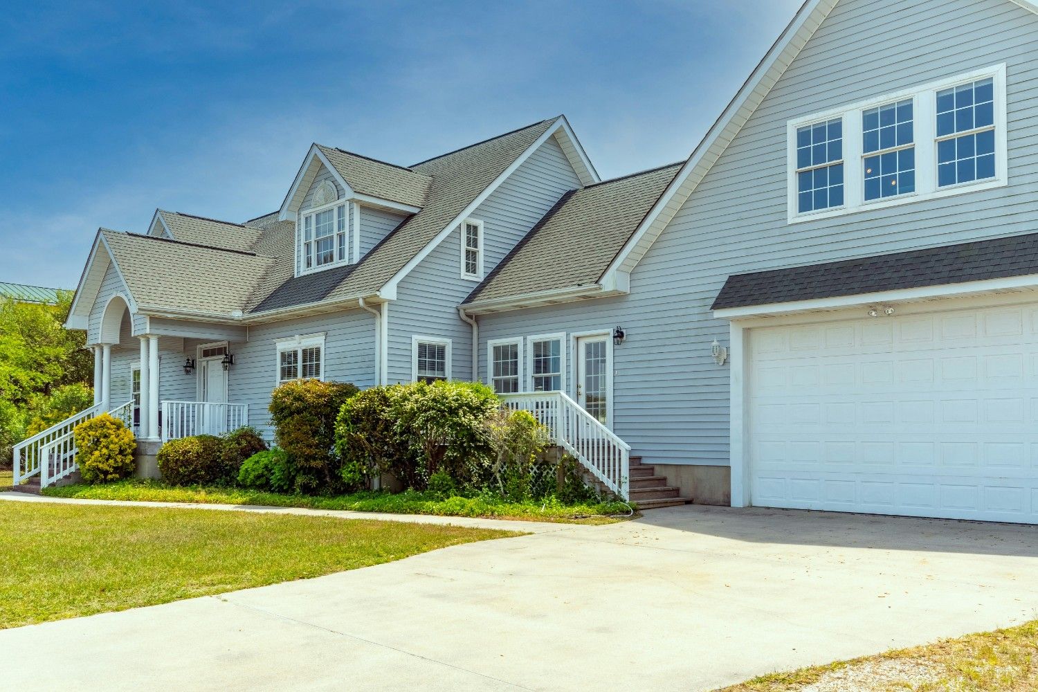 Modern residential home design by professional architects near me in Ludhiana featuring sleek glass and stone finish.